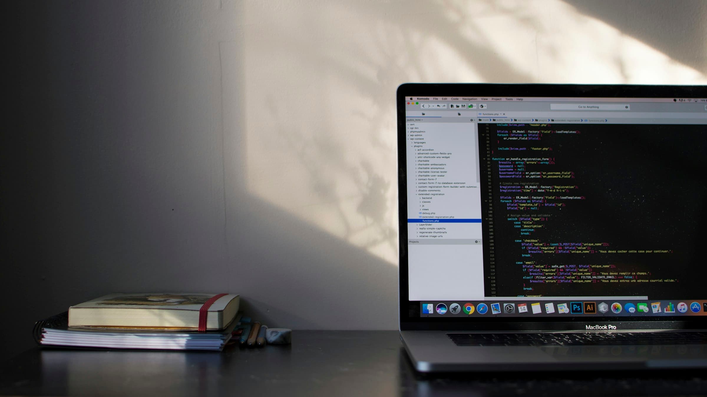 MacBook Pro on a desk displaying source code