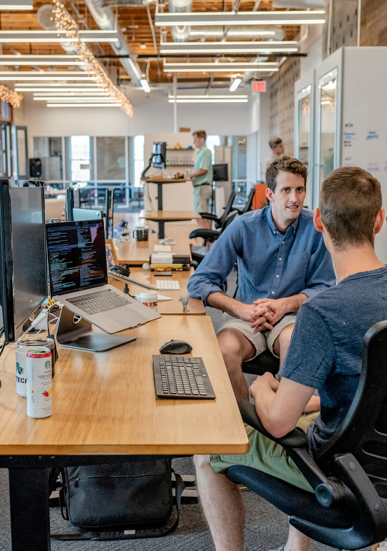 Two developers reviewing code together at a standing desk